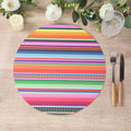 Colorful striped round placemat on a wooden table with utensils.