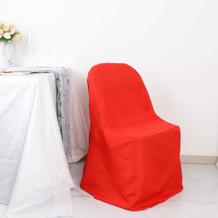 Red chair cover draped over a chair in a decorated dining setting.