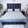 Pure cotton bed sheet set with floral design and matching pillow covers on a modern bed