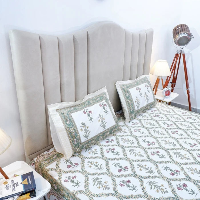 Jaipuri cotton bed sheet featuring intricate floral patterns on a stylish bed with matching pillows