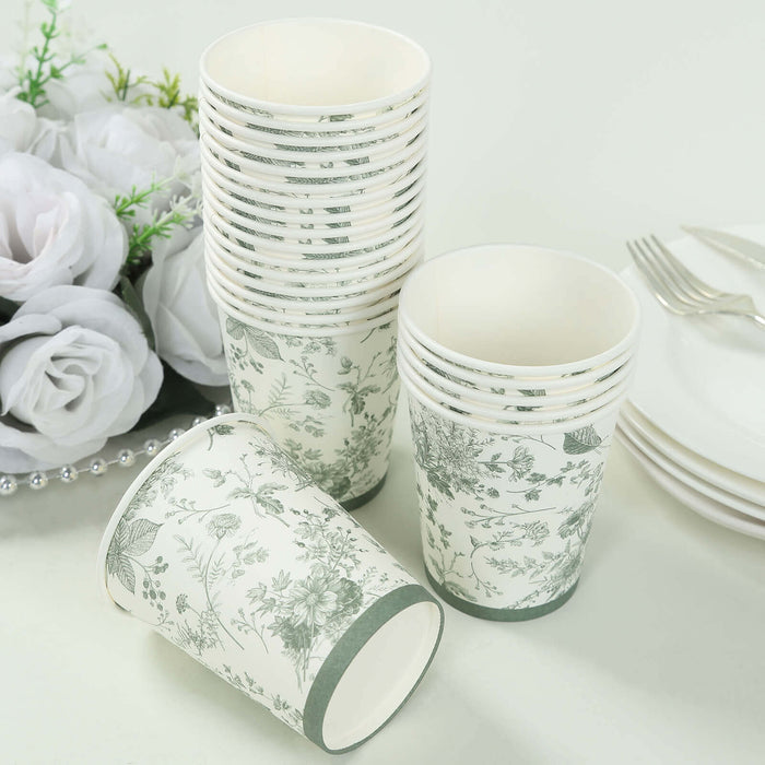 Floral-patterned disposable cups stacked with one tipped over on a white background.