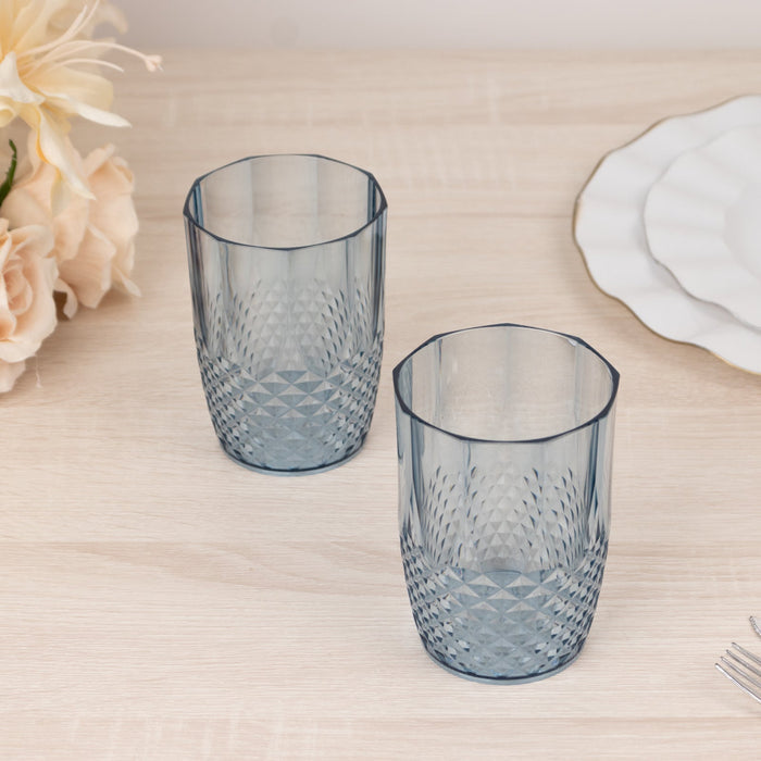 Set of two blue decorative glasses on a wooden table.