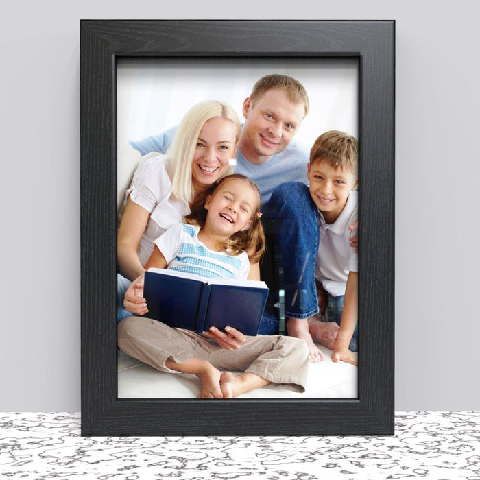 A4 picture frame options showcasing a happy family reading together in a black frame.