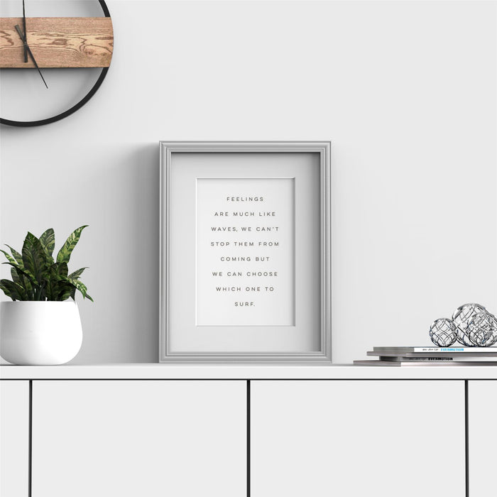 Silver picture frame with white mount displaying motivational quote in modern decor setting.