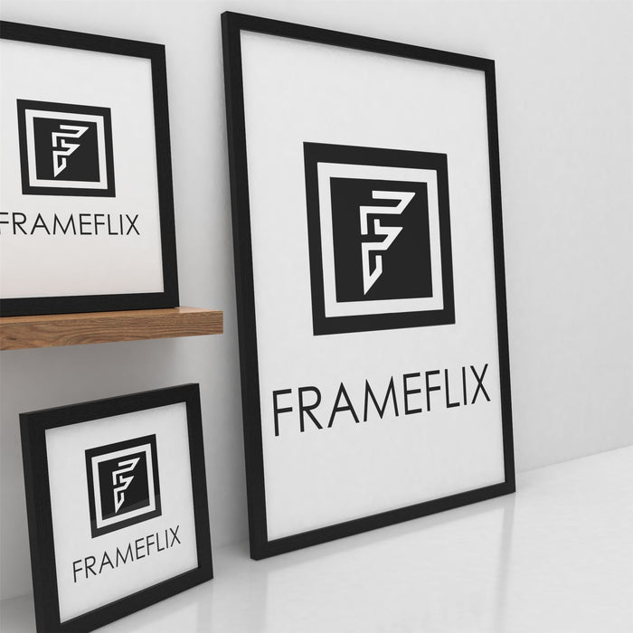 FrameFlix black picture and poster frames displayed on a shelf against a white wall.