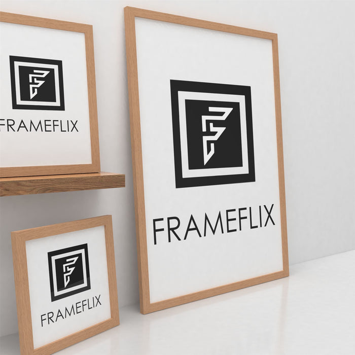 FrameFlix oak picture and poster frame displayed on a shelf with a warm oak finish.