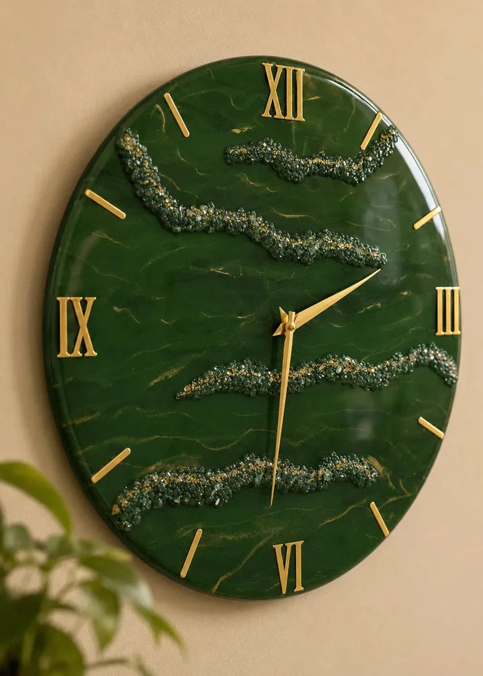 Green marble-style wall clock with gold Roman numerals on a beige wall.