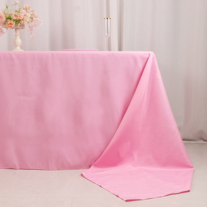 Pink tablecloth draped elegantly over a table in a soft setting.