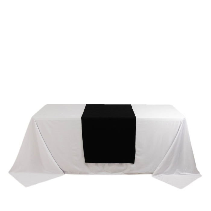 Black table runner on a white tablecloth for elegant dining decor. #whtbkgd