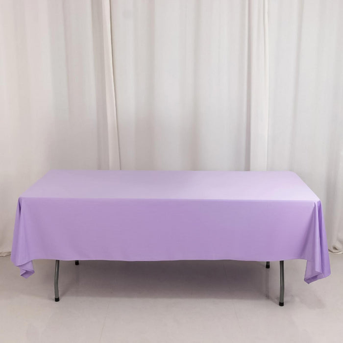 Purple tablecloth on a folding table against a plain backdrop.