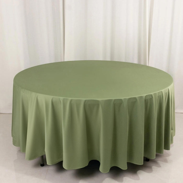 Round olive green tablecloth on a round table with draped edges