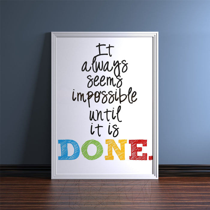 White picture frame displaying motivational quote 'It always seems impossible until it is DONE.'