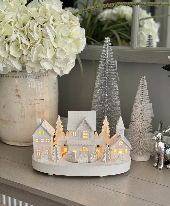 White Wooden Christmas Village Scene With Moving Train And Lights.